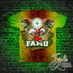 a green and yellow shirt with the words famu on it in front of a brick wall