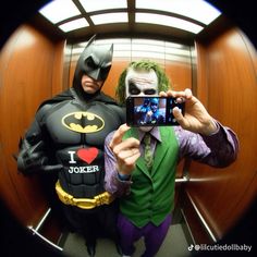 two people dressed up as batman and the joker taking a selfie with their cell phone