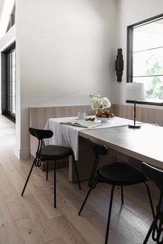 the dining table is set with two chairs