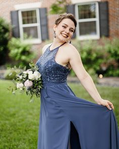 a woman in a blue dress is posing for the camera