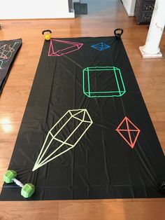 a black mat with different colored shapes on it