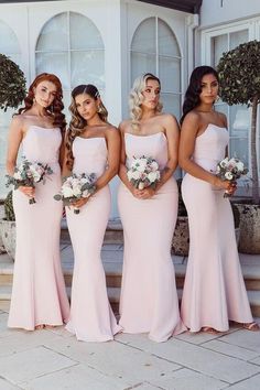 the bridesmaids are all wearing different styles of pink dresses and bouquets in their hair