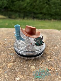 a toy cowboy's hat is sitting on top of an ice - cubet