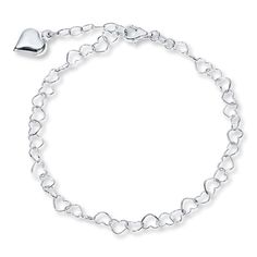 This 9-inch sterling silver heart link chain anklet is decorated with a dangling puffed heart charm. The anklet fastens with a lobster clasp. Pandora Anklet, Hammered Silver Jewelry, Charm Anklet, Heart Anklet, Jewelry Education, Jewelry Advice, Jewelry Charms Pendants, Jewelry Accessories Ideas, Puffed Heart