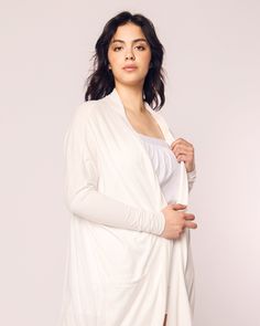 At the tippy top of the cotton jersey pecking order is 100% Peruvian Pima cotton. Our Pima Collection is sewn from this exquisite fabric: luxurious, supple jersey knit pajamas that drape beautifully and continue to soften with each washing. Buttery and smooth, yet breathable, this collection is yarn-dyed to prevent fading and is destined to become a fixture of your soothing bedtime ritual. A duster is like a chic supple trapeze dress that conveniently slips on like a jacket. Ours, in our heavenl Soft Stretch Tops For Loungewear, Relaxed Fit Soft Cotton Tops, Cozy Soft Cotton Tops, Soft Cozy Cotton Tops, Spring Soft Knit Loungewear Tops, Soft Stretch Cotton Sleepwear, White Stretch Cotton Cardigan, White Organic Cotton Long Sleeve Sleepwear, Organic Cotton Tops For Fall Loungewear