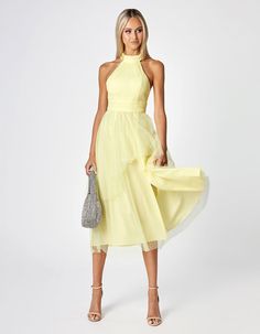 Timeless elegance meets modern sophistication. This midi-length masterpiece features a halter neck and a tiered skirt, exuding a sense of grace and allure with every movement. This dress is as luxurious as it is comfortable, ensuring you feel as good as you look. Pair it with strappy sandals and delicate jewellery for a feminine and ethereal look, or opt for statement heels and bold accessories to add a touch of glamour.  Features Halter Neckline Bust cups A-line skirt  Fabric Content Nylon Mesh SHELL: 100% Nylon LINING: 97% Polyester, 3% Spandex Fit Information Regular fit - stretch in the fabric The model wears size 6 Height: 178cm Bust: 81cm Waist: 61cm Hips: 86.5cm THIS ITEM IS  NOT ELIGIBLE  FOR CHANGE OF MIND, REFUNDS, EXCHANGES OR STORE CREDITS DUE TO BEING ON FINAL SALE Halter Neck Midi Dress, Statement Heels, Delicate Jewellery, Skirt Fabric, Bold Accessories, Delicate Jewelry, Halter Neckline, Tiered Skirt, Milky Way