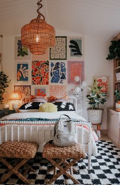 a bedroom decorated in orange, white and black with lots of pictures on the wall