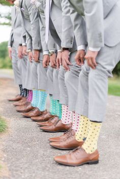 a row of men in suits and colorful socks