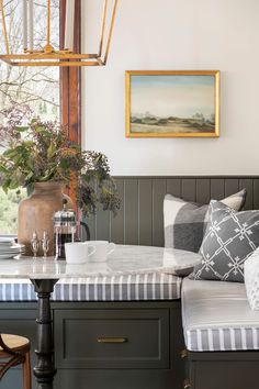 a living room filled with furniture and a painting on the wall