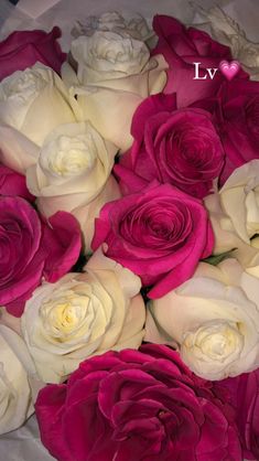 a bouquet of white and pink roses with the word love written on it in cursive writing