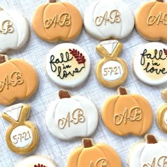 decorated cookies are arranged in the shape of pumpkins and monogrammed with names