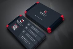 two black and red business cards sitting on top of a dark surface, with the company logo