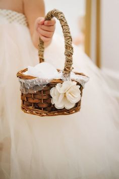 a person in a white dress holding a basket