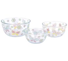 three glass bowls with butterfly designs on the bottom and one bowl has a flower design