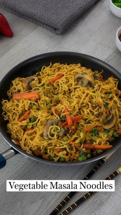 vegetable masala noodles in a skillet with chopsticks