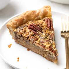 a slice of pecan pie on a white plate