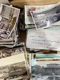 many old postcards are piled on top of each other