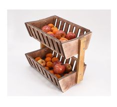 two wooden baskets filled with apples on top of each other