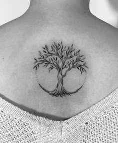 a woman with a tree tattoo on her back