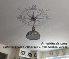 the compass is hanging from the ceiling in the kitchen