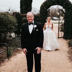 a man in a tuxedo standing next to a woman in a wedding dress