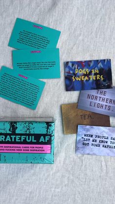 several different types of business cards laid out on a bed