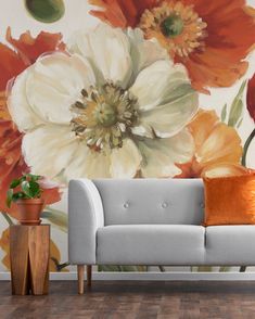 an orange and white flower wall mural in a living room