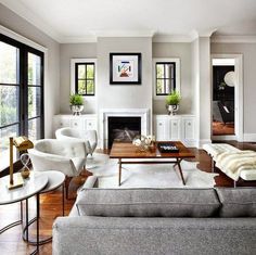 a living room filled with furniture and a fire place