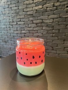 a watermelon candle sitting on top of a table