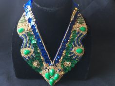 "Stunning hand embroidered bib necklace: * Truly unique statement piece for special occasions, festivals, weddings. * Intricately beaded design with emerald green, blue and gold seed beads and sequins. * Focal pieces are emerald green stones which bring the whole design together. * Necklace measures 6 1/4\" long and 6\" across. * Brilliant blue ribbon closure allows for adjustable length and adds uniqueness to this one of a kind piece. **Free Shipping**" Peach Necklace, Emerald Green Stone, Statement Bib Necklace, Green Stones, Bib Necklaces, Pretty Green, Black Chain, Bib Necklace, Green Crystals