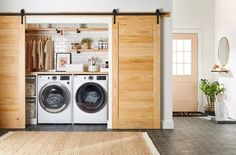 a washer and dryer in a room with wooden doors