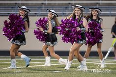 the cheerleaders are dressed in purple and black