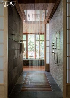 a bathroom with a large shower head and wooden walls, along with tiled flooring