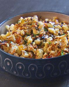 a bowl filled with food sitting on top of a table