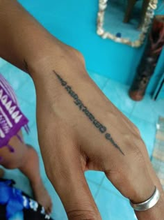 a person with a small tattoo on their left hand