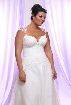 a woman in a white wedding dress posing for the camera