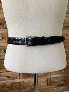 "This is a really nice vintage belt! It is genuine alligator, one piece steer hide lined. The belt has a curve to it making for a very nice fit & has a tapered tip to easily fit into the buckle and rectangle holes to better allow for some movement while wearing. It is very well made, and high-quality. No maker or size visible but guessing this to be a size small/medium, but do check measurements please.  This belt is in very good condition with some wear showing on the gold toned metal post. The buckle itself is more of a silver tone. Some wear showing to the inside where the belt has been latched, scratches, etc. that will not be seen, exterior has very minor wear. See photos for details. Size S/M Full length 41 1/2\" Width 1 1/4\" Waist 33\" - 37\"" Black Formal Belt With Antique Buckle, Formal Black Belt With Antique Buckle, Vintage Fitted Belt For Formal Wear, Formal Black Antique Belt Buckle, Vintage Fitted Belt For Formal Occasions, Fitted Vintage Style Belt For Formal Wear, Vintage Formal Fitted Belt, Adjustable Formal Belts And Suspenders, Classic Black Belts And Suspenders With Antique Buckle