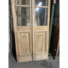 an old wooden double door with glass