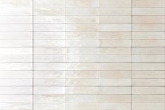 a white tile wall that is very clean and ready to be used as a background