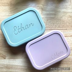 two personalized plastic containers sitting on top of a wooden table