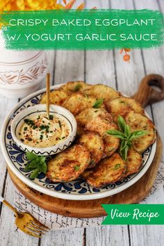 crispy baked eggplant with yogurt garlic sauce on a blue and white plate