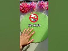 a person holding a green frisbee with the words no glue on it