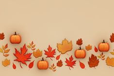 an arrangement of autumn leaves and pumpkins arranged in a row on a beige background