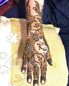 a woman's hand is decorated with hennap on her left arm and wrist