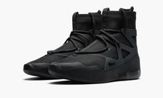 The Nike Air Fear of God 1 “Triple Black” is an essential for fans of Jerry Lorenzo’s upscale fashion label, Fear of God, and for those who enjoy the moody all-black-everything aesthetic.  Lorenzo joined a very short list of non-athletes who have created their own silhouettes under the Nike umbrella when he debuted the Air Fear of God 1 in 2017.  The hybrid performance hoops and lifestyle shoe sports a black suede overlay on the toe while tonal nylon graces the collar, heel, and mid-panel.  The Nike Fear Of God, Triple Black Shoes, Nike Air Fear Of God, Low Jordan 1, Jerry Lorenzo, Converse Nike, Upscale Fashion, Exclusive Sneakers, Baskets Nike