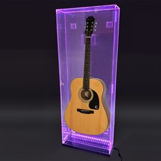 an acoustic guitar in a clear acrylic case with purple lights on the sides