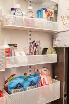 an open refrigerator door with various items on the shelves and in bins next to it