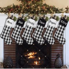 christmas stockings hanging over a fireplace with presents