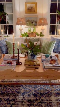 a living room filled with lots of furniture and decor on top of a wooden table