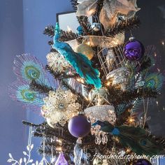 a christmas tree decorated with peacocks and ornaments